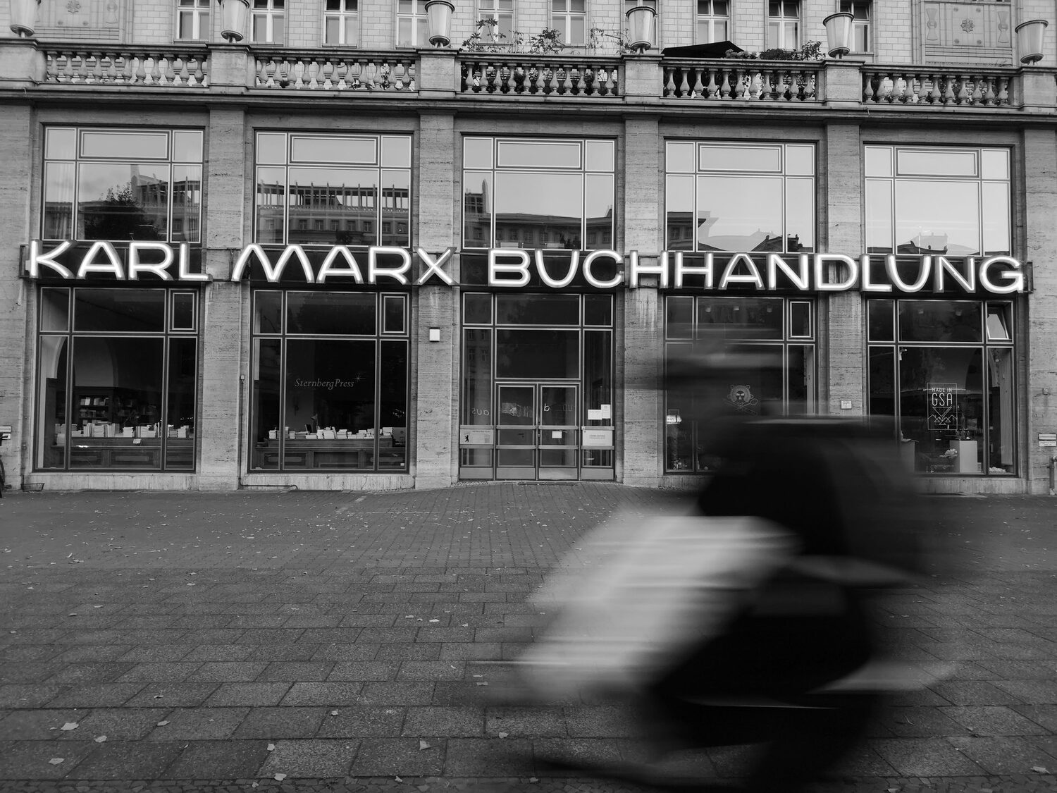 karl marx buchhandlung bookstore berlin - karl marx allee cyclist